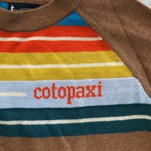 Cotopaxi cashilama unisex sweater. Earthtone stripes on warm brown. W-L, Mens M.